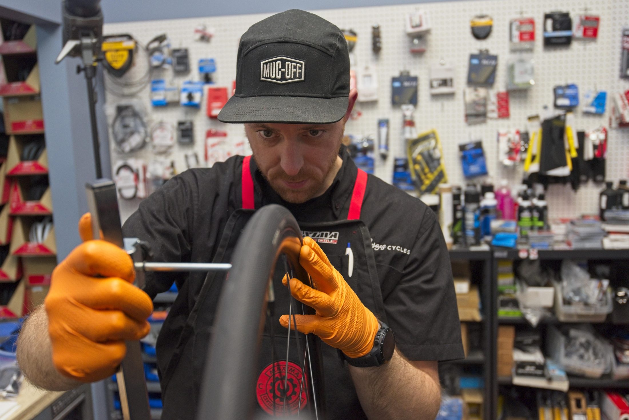 Bike shop mechanic truing a wheel