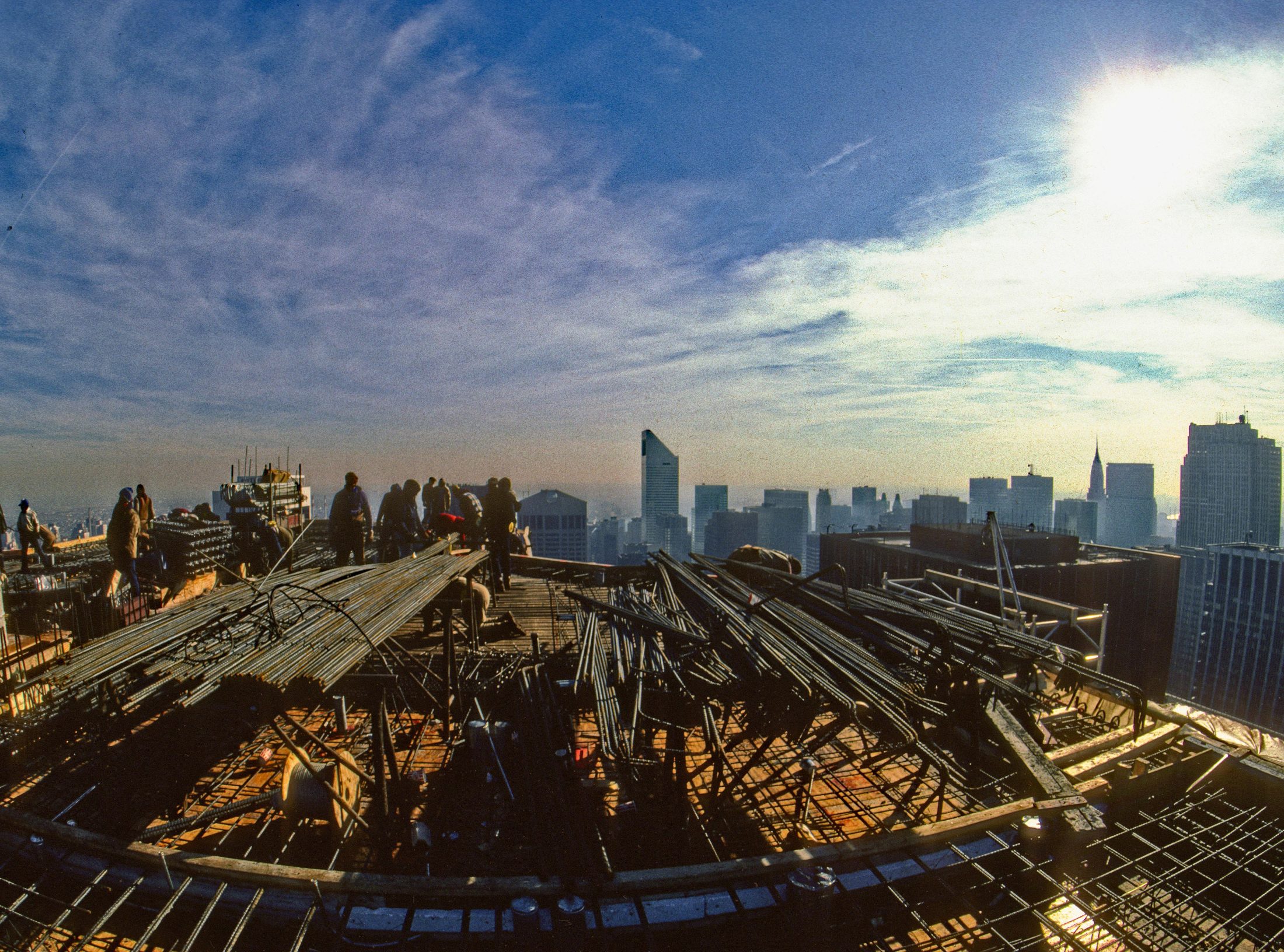 Fisheye view of workers on a high-rise construction deck
