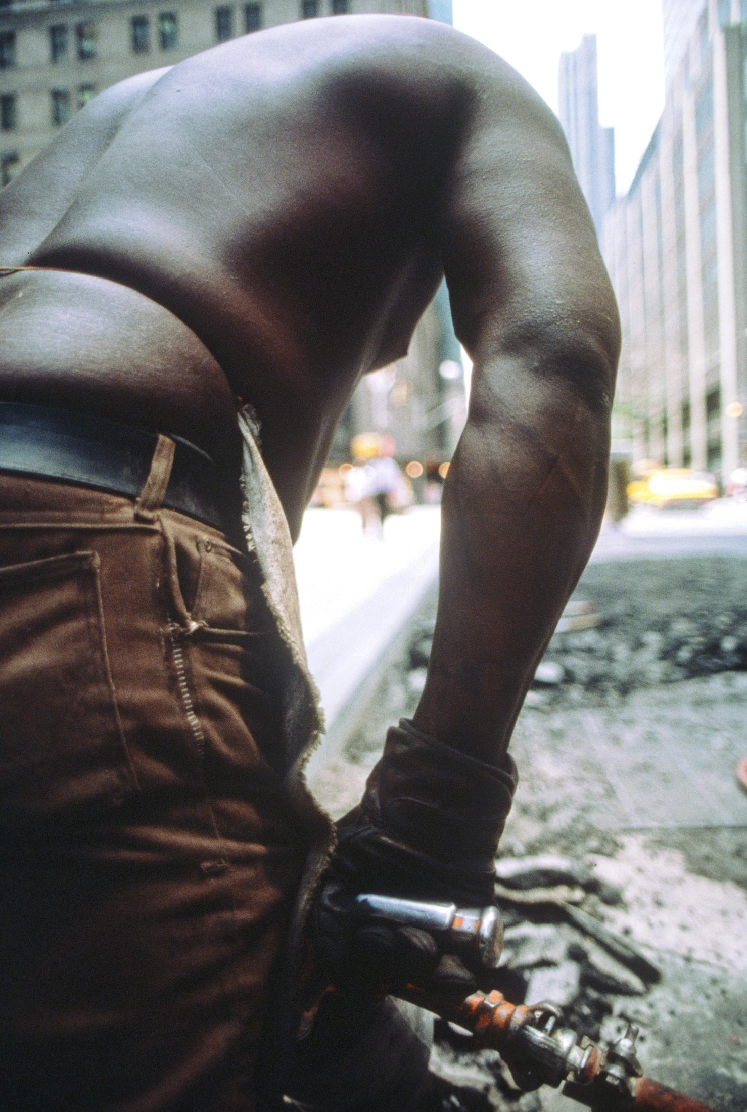 Construction worker's back and arm, jackhammer detail