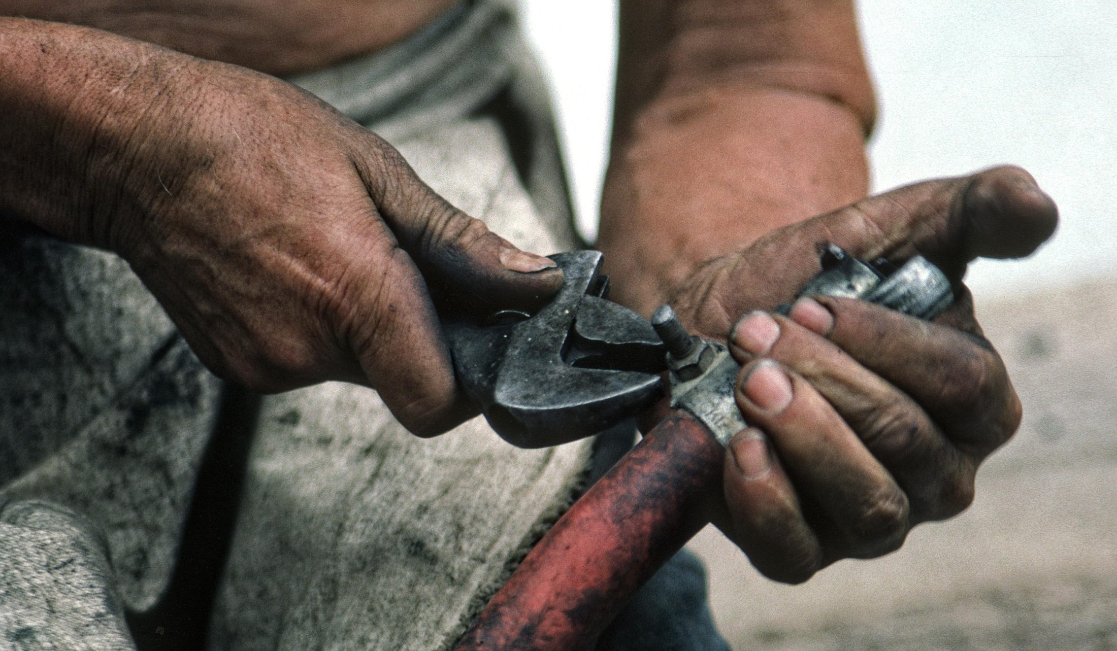 Hands adjusting a jackhammer bit, close detail