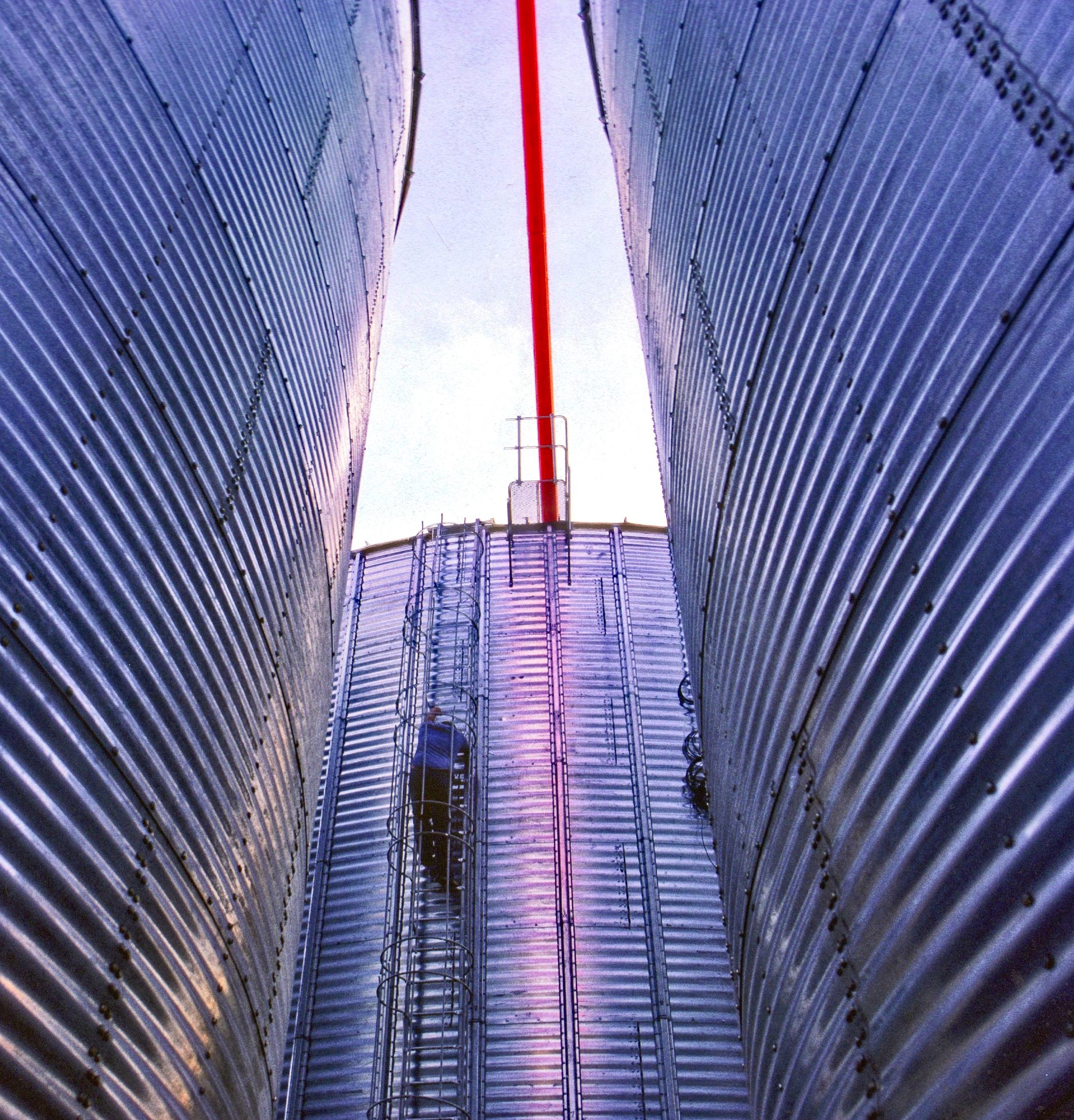 Grain bins from below, looking up between them