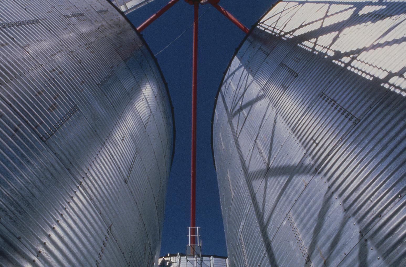 Grain bins from above, red support beams