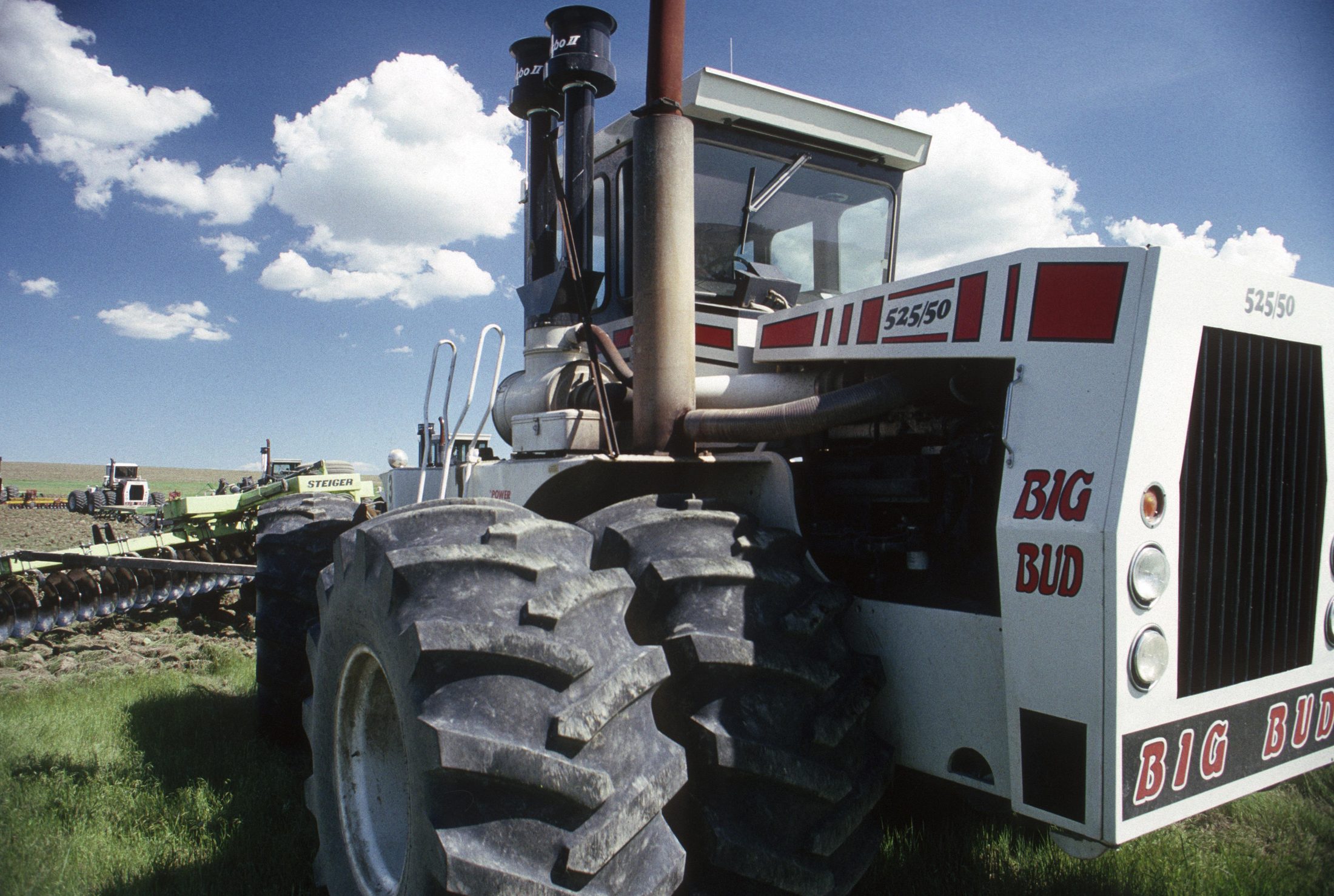 Big Bud tractor in a field under a blue sky