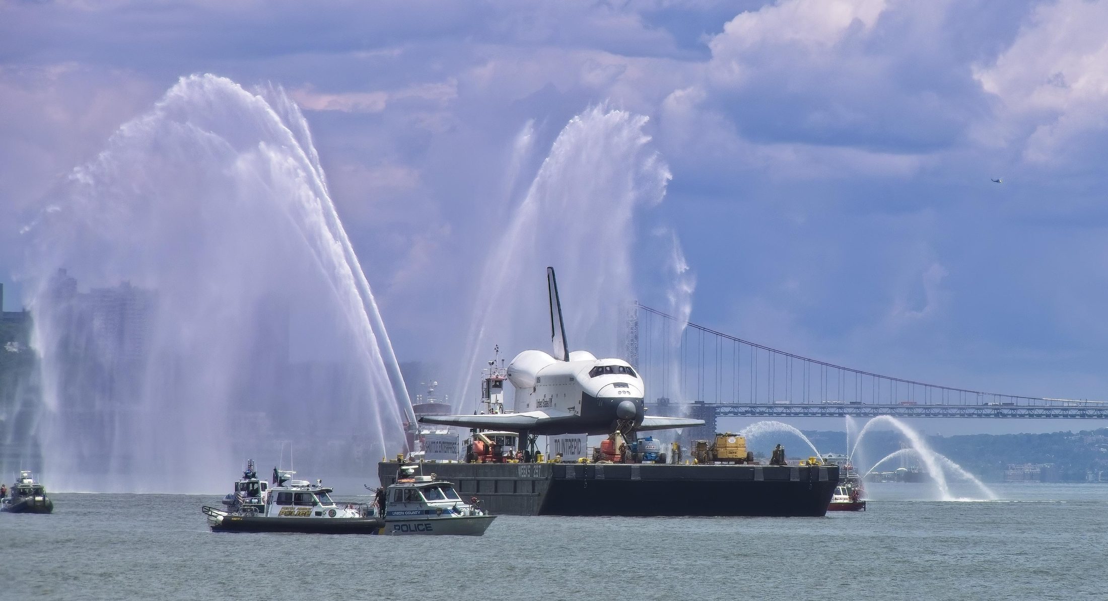 Space Shuttle Enterprise on transport barge, NYC skyline