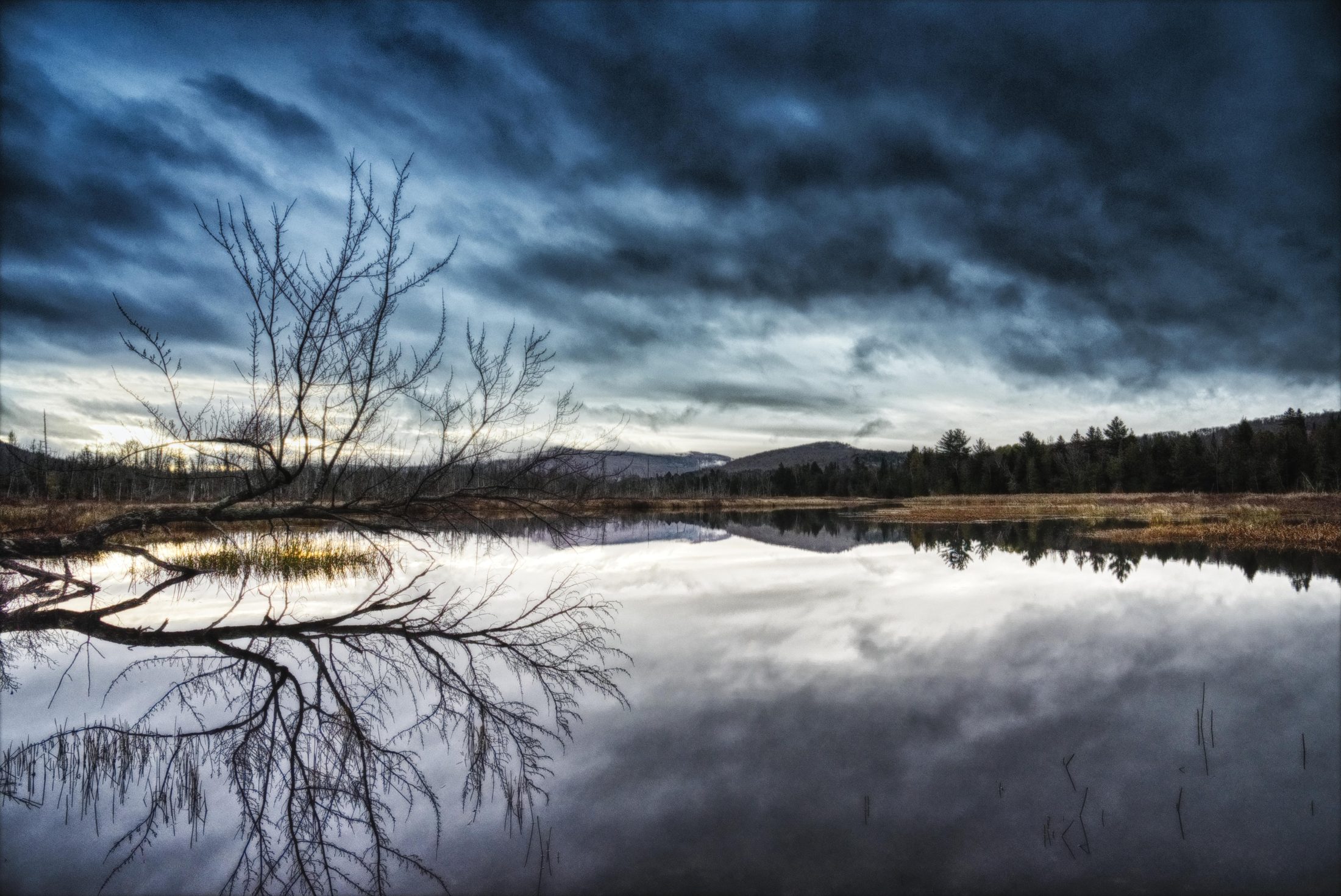 Storm clouds over a still lake