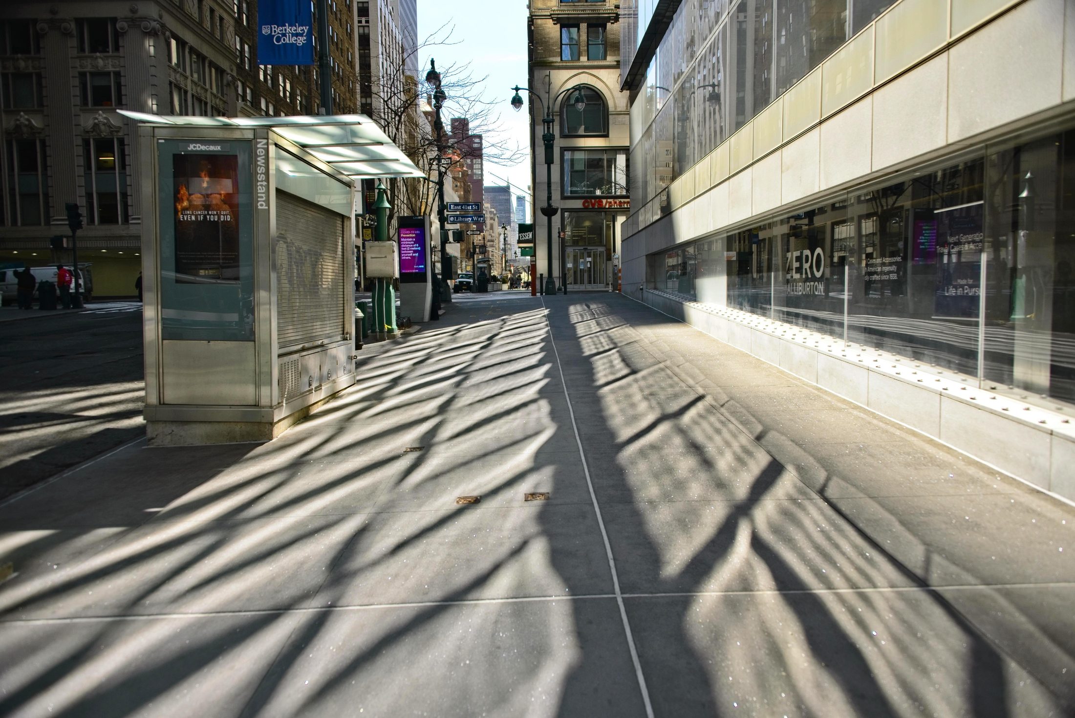 Empty Manhattan sidewalk, long shadows