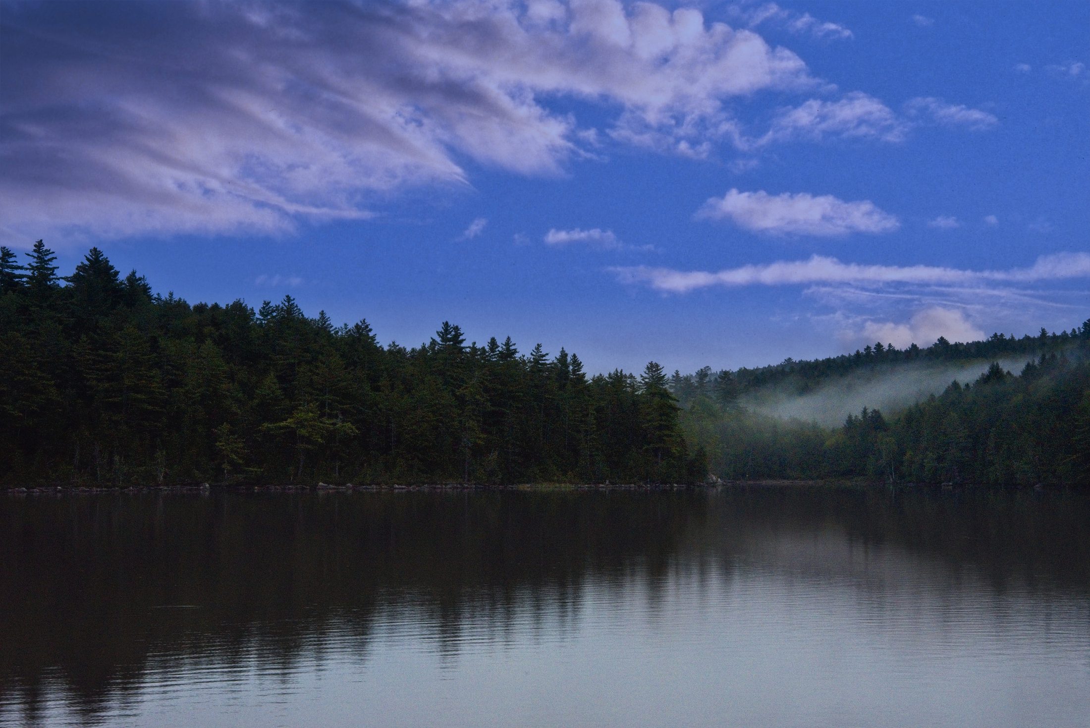 Misty pine-lined lake at dusk, Fourth Debsconeag Lake