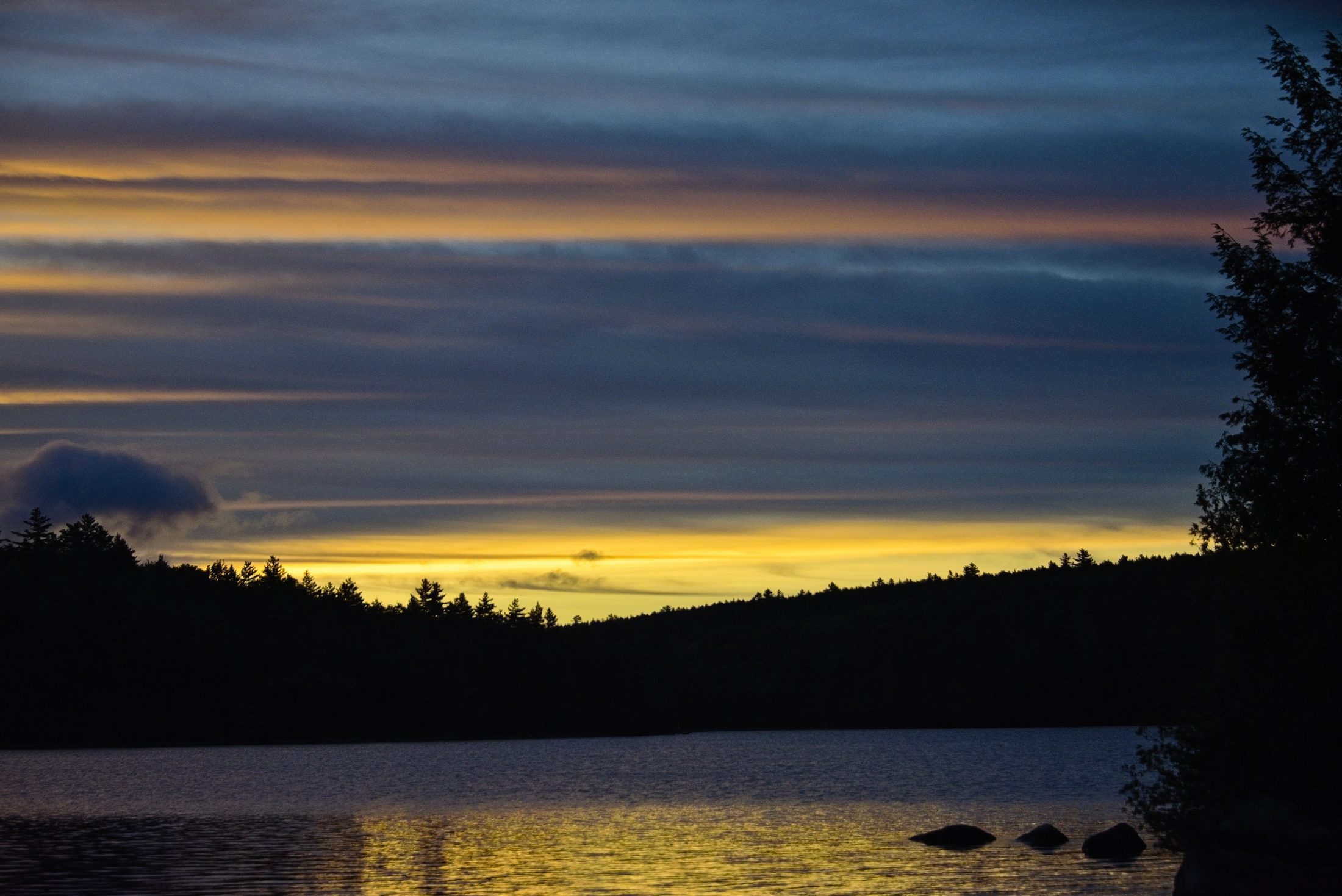 Striped sunset sky over Fourth Debsconeag Lake