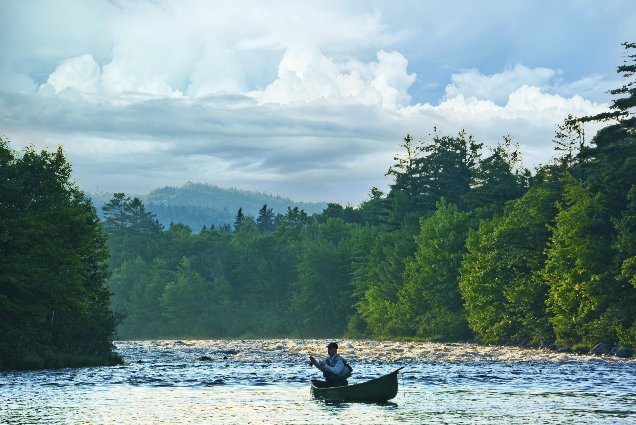 Fly fishing from a canoe near Big Eddie