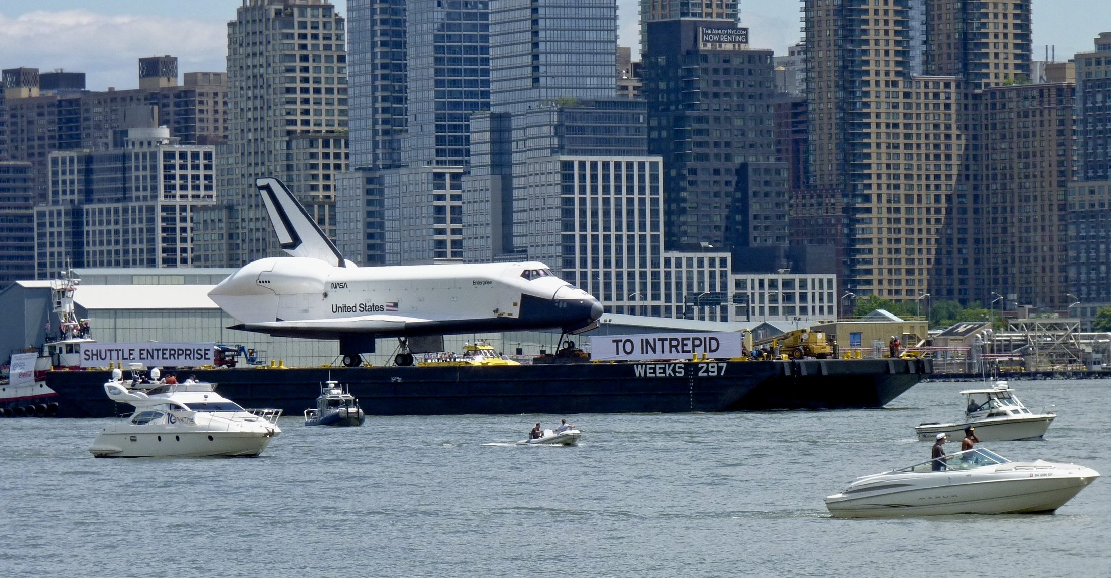 Space Shuttle Enterprise on transport barge, wide view with skyline